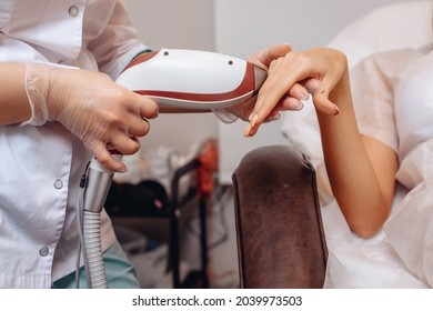 Making your hands look younger and more well-groomed. Get rid of wrinkles and bad skin on the hands. Performing beauty services in a beauty salon for a young client. Modern self-improvement.