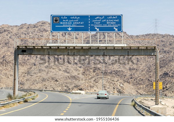 Makkah, Saudi Arabia, February 22 2020: Road\
sign in the vicinity of Mecca that non Muslims do have to drive\
around the holy city Mecca in Saudi\
Arabia