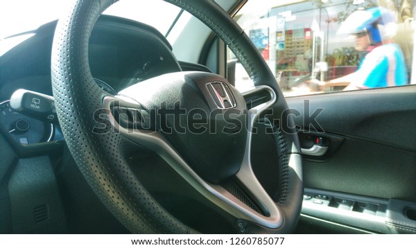 MALACCA, MALAYSIA - DECEMBER 17, 2018 : View\
of HONDA steering and meter. Focus on HONDA logo, Black Steering\
Wheel And Silver, editorial honda\
brv.