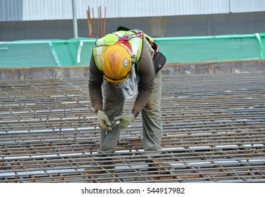 MALACCA, MALAYSIA -SEPTEMBER 28, 2016: Construction workers install and fabricating floor slab reinforcement bar at the construction site. The reinforcement bar is tie together using tiny wire.  - Shutterstock ID 544917982