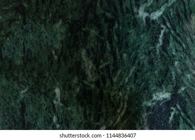 Malachite marble stone, natural texture of green malachite color marble. Design background of green marble with white stripes and geode.