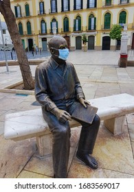 Malaga, Spain; 03 23 March 2020: Statue Of Pablo Picasso With A Medical Mask On His Face From The Coronavirus Virus, Covid-19, In The Plaza De La Merced In Malaga, Spain