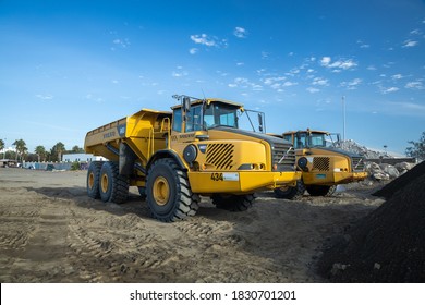 Malaga, Spain; 10/10/2020; Construction machinery in San Andres beach in Malaga city - CAT excavator wheeled truck in the construction site at the beach