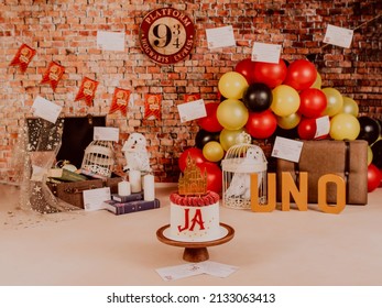 Malaga Spain 6 March 2022 Harry Potter Style First Birthday Photo Session In A Photo Studio With Balloons, Suitcases, Books, Letters And Candles