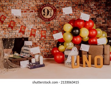 Malaga Spain 6 March 2022 Harry Potter Style First Birthday Photo Session In A Photo Studio With Balloons, Suitcases, Books, Letters And Candles