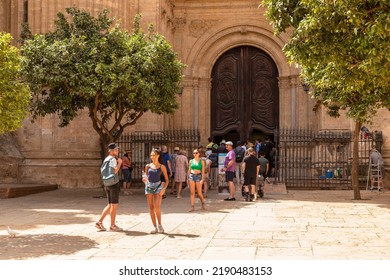 Malaga, Spain, June 13, 2022; Tourists Wait At The Entrance Of Malaga Cathedral Or The Santa Iglesia Catedral Basílica De La Encarnación.