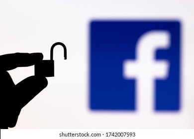 Malaga, Spain - May 18th, 2020: Facebook Security. Holding An Unlocked Padlock Besides A Facebook Logo