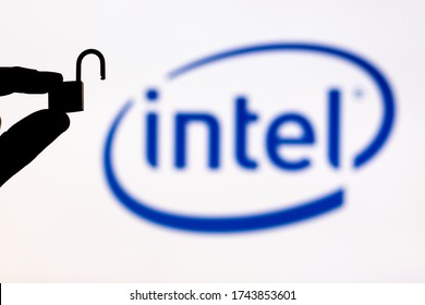 Malaga, Spain - May 18th, 2020: Intel Security. Holding An Unlocked Padlock Besides An Intel Logo