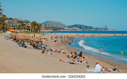 Malaga, Spain - May 26, 2022: A View Over La Malagueta Beach In Malaga, Spain, With Many People Enjoying The Good Weather In A Sunny Spring Day