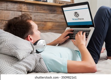 MALAGA, SPAIN - NOVEMBER 10, 2015: Wordpress brand logo on computer screen. Man typing on the keyboard. WordPress is a free and open-source blogging tool and a content management system (CMS).