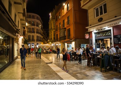 MALAGA, SPAIN - OCTOBER, 2016: Cityscape. View Of The Street Cafe At Night With Visitors.
