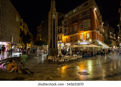 MALAGA, SPAIN - OCTOBER, 2016: Cityscape. View Of The Street Cafe At Night With Visitors.
