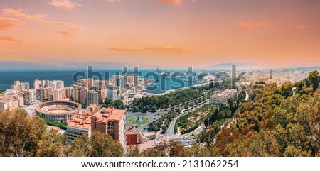Malaga, Spain. Panorama Cityscape Elevated View Of Malaga In Sunny Summer Evening. Altered Sunset Sky.