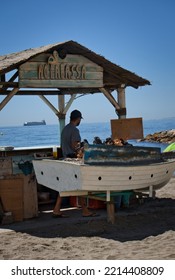 MALAGA, SPAIN, SEPTEMBER, 9, 2022: Chiringuito De Espetos On Malaga Beach With A Cook Preparing Food On A Sunny Day.