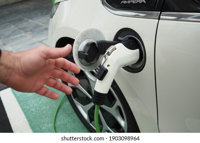 Malaga, Spain-January 11, 2021 Concept: ecological clean power. Electric car charging in a public parking.