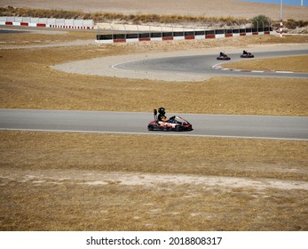 Malaga, Spain-July 2, 2021 A Driver With Gear And Helmet Drives A Racing Car. In Action. Go Kart Racing, Street Karting, Renting.