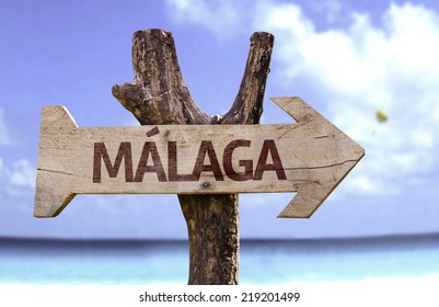 Malaga Wooden Sign With A Beach On Background