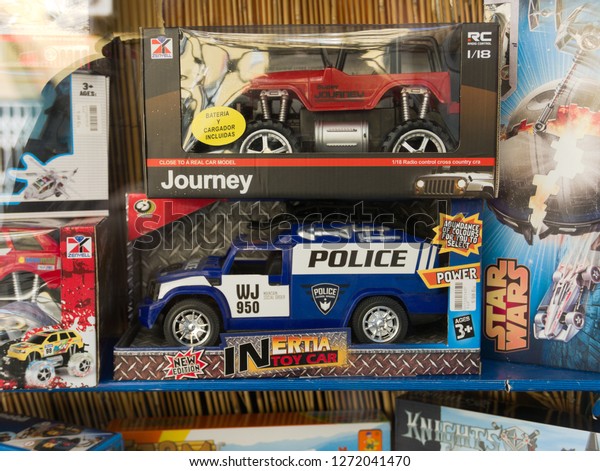 Malaga/Spain - 12-30-2018 : Packed\
toys cars, one red and one blue, under blister on \
shelves.