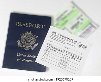 malaga-spain-02-15-2021 - Covid-19 vaccination record card next to us passport. Illustration of vaccination needed by airplane companies to travel, tourism, business trips. - Shutterstock ID 1923670109