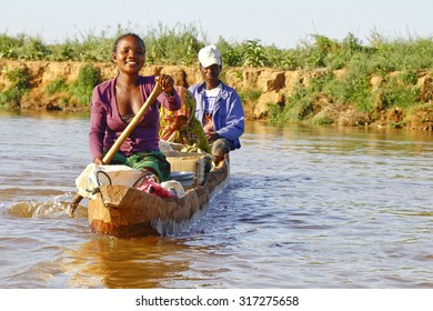 Malagasy People Crossing The Inlets In An Outrigger Canoe