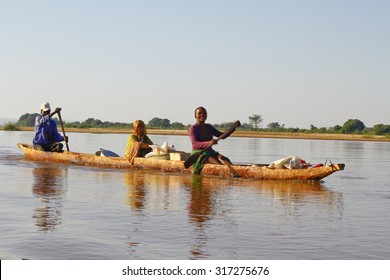 Malagasy People Crossing The Inlets In An Outrigger Canoe