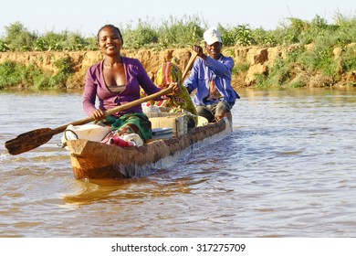 Malagasy People Crossing The Inlets In An Outrigger Canoe