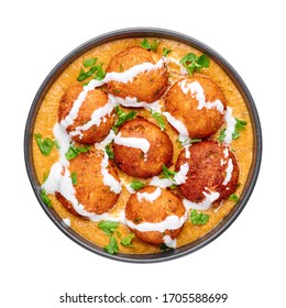 Malai Kofta Curry in black bowl isolated on white background. Malai Kofta is indian cuisine dish with potato and paneer cheese deep fried balls in onion tomato gravy with spices. Indian Food.