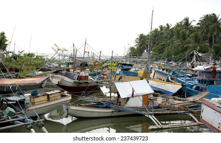 Malandog,Panay Island, Philippines - December 4,2014: Fishermen Putting Outriggers Out In The River To Protect The Boats From Super Typhoon Hagupit (Ruby)