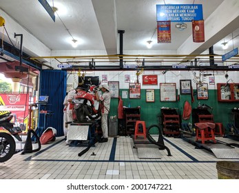 Malang, Indonesia -25 May, 2021: Atmosphere At A Motorcycle Service Shop In Malang City When Workers Are Busy Repairing Customers' Motorbikes