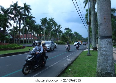 Malang, Indonesia - April 23 2022 : Idjen boulevard is a landmark of Malang city with it's large pedestrian walk under palm trees and old dutch architecture houses on the sides