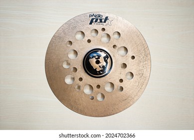 MALANG, INDONESIA - August 14, 2021 : Rustic and drity cymbal with holes made from bronze