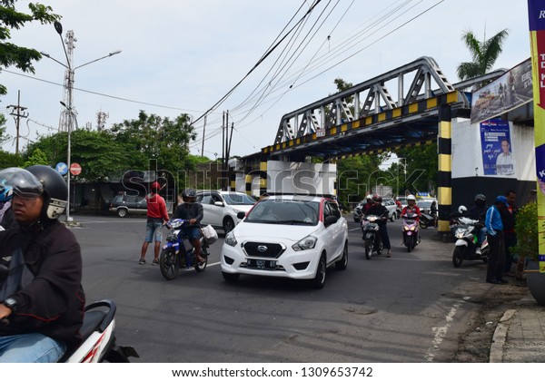 Malang,\
Indonesia - December 9, 2018: Views of motorized vehicles passing\
on the streets of Malang, East Java,\
Indonesia