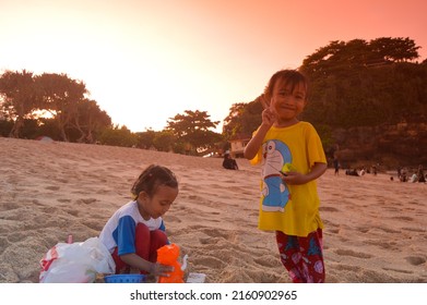 Malang, Indonesia - May 7, 2022: photo of children playing on the beach, to be precise, the beach of Goa Cina, Malang