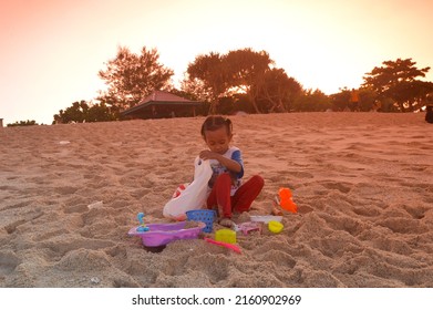 Malang, Indonesia - May 7, 2022: photo of children playing on the beach, to be precise, the beach of Goa Cina, Malang
