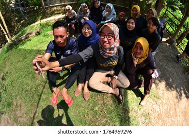 MALANG, INDONESIA - NOVEMBER 03, 2018: A Group People Are Taking Selfie Together Using Fish Eye Lens Ar Hotel Park In Malang, Indonesia.