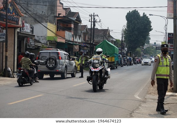 Malang, Indonesian - April 2021,\
Escorting the motorcade of President Joko Widodo in Malang, to\
inspect the location of the earthquake in the Dampit area, East\
Java.