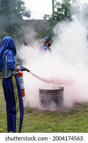 Malang, Indonesian - June 2021, Extinguishing Fire Using Aspar By School Students Guided By Firefighters