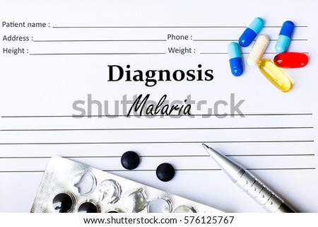 Malaria - Diagnosis written on a piece of white paper with medication