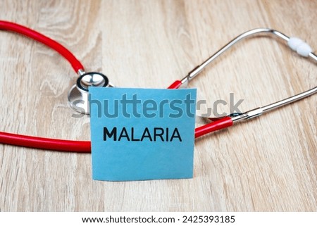 MALARIA text, inscription on the background of a stethoscope. Malaria medical concept.