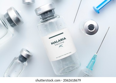 Malaria Vaccine Concept: Vials And Syringes On A White Plane