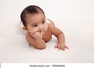 Malay Baby Girl Laying On The Bed Licking Fingers