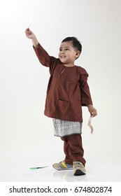 Malay Boy Holding Green Package During Hari Raya