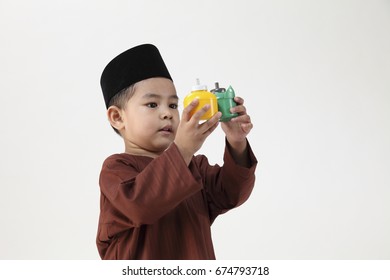 Malay Boy Playing With The Colorful Pelita