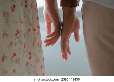 Malay couple's hands almost touching 