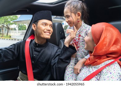 Malay Family Inside The Car Wearing Traditional Costume For Hari Raya Festive