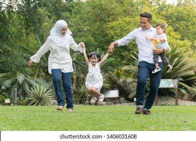 Malay Family At Recreational Park Having Fun