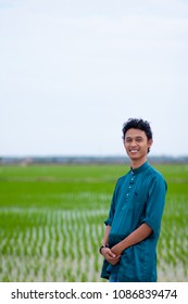 A Malay Guy Wearing Malaysia's Traditional Attire, Baju Melayu At Paddy Field