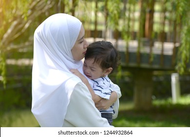 Malay Mother With Crying Son In The Park