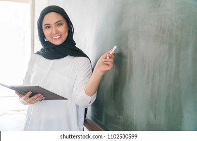 Malay School Teacher At The Classroom Wearing Hijab 