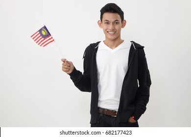 Malay Teenage Holding A Small Malaysia Flag